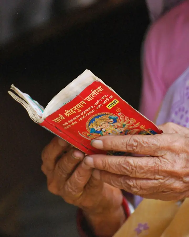 Hands holding a small devotional book
